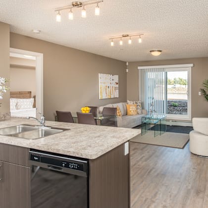 a modern kitchen with a marble countertop and stainless steel appliances.