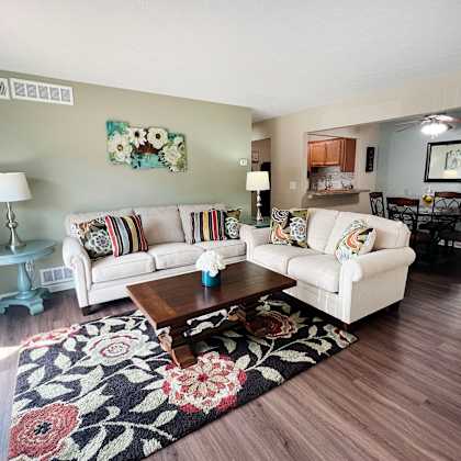 a living room with two couches and a coffee table at fox run apartments, cincinnati