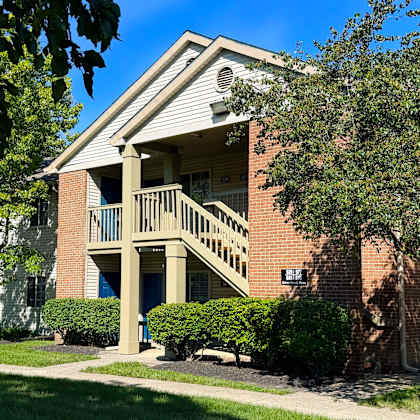 a brick building with a balcony and a sign that says