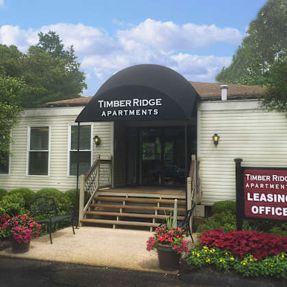 a white building with a sign that reads apartments leaseing office  at timber ridge apartments, cincinnati, ohio