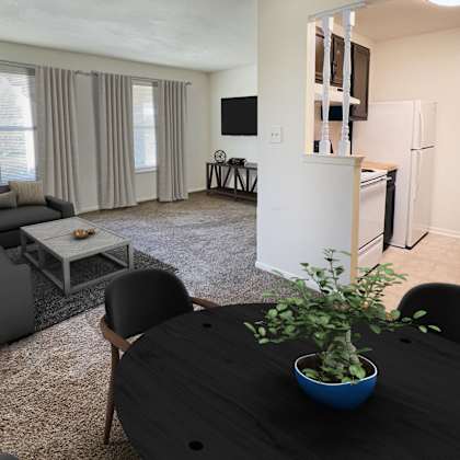 a living room with a table and a couch and a kitchenat revere village apartments, centerville