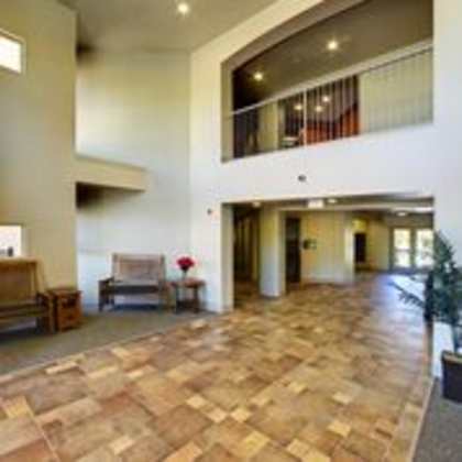 a hallway with a bench and a chair.