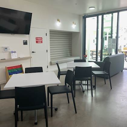 a conference room with a white table and black chairs.