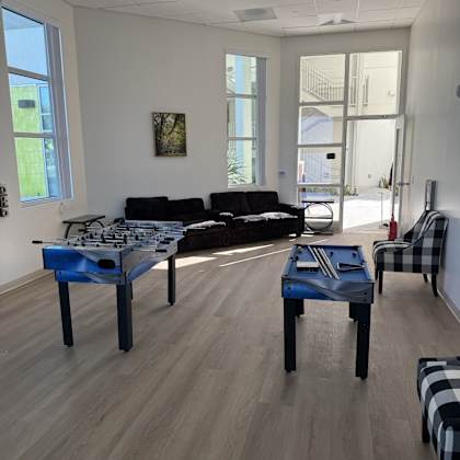 a room with a blue table and black and white checkered chair.