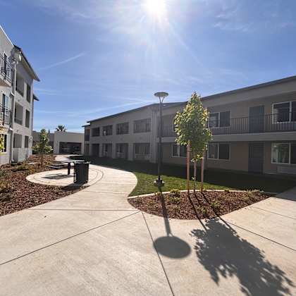a sunny day at a residential complex with a clear blue sky.