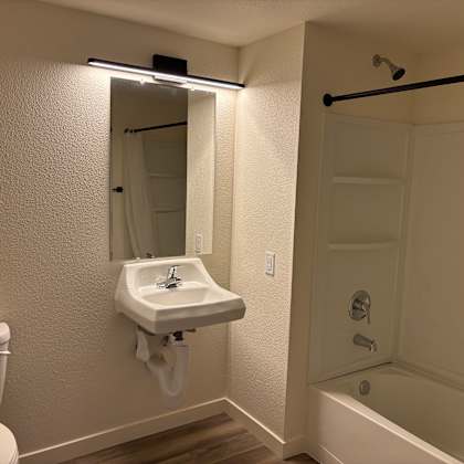a white sink with a mirror above it in a bathroom.