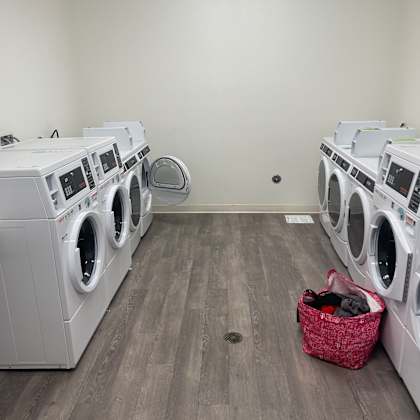 a row of washing machines in a laundry room.
