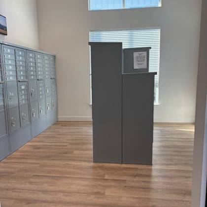 a room with a wooden floor and a cabinet with drawers.