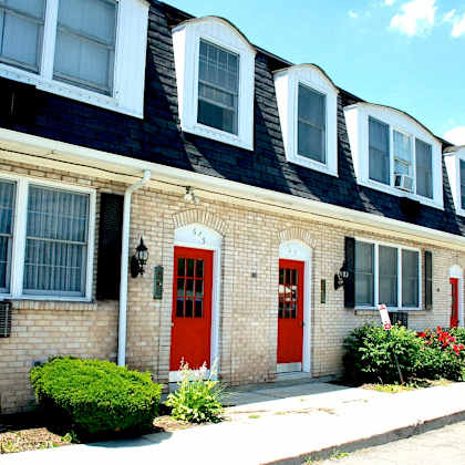 a house with a red door and windows.