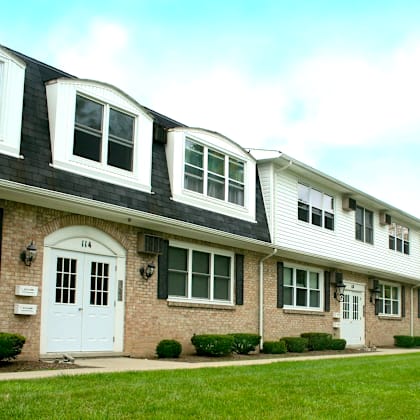 a row of houses with the first one having a white door.