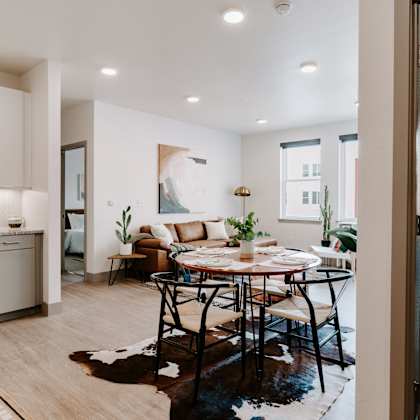 a modern kitchen with a dining table set for four.