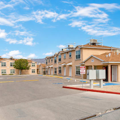 a sunny day at the apartment complex with clear blue skies.