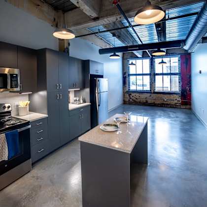 a kitchen with a large island and stainless steel appliances at conwood flats, memphis, tennessee