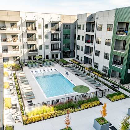 a swimming pool is surrounded by apartment buildings at harbor side at conwood flats apartments, memphis, tn, 38107