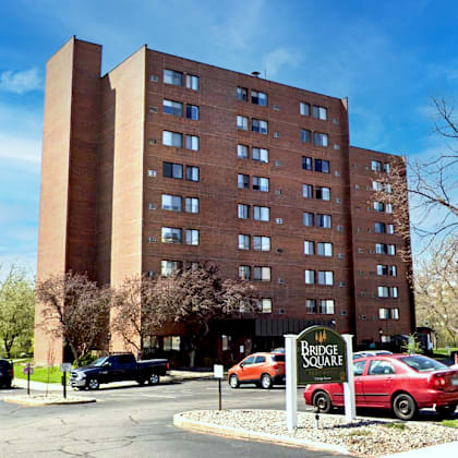 a large brick building with a sign that says bridge square in front of it.