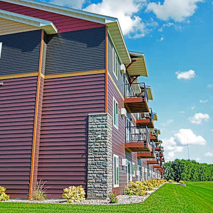 a red building with a balcony on the second floor.