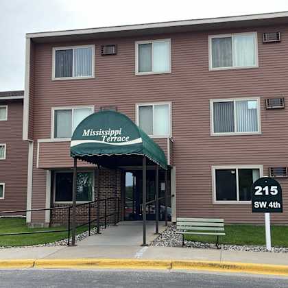 the front of the mississippi terrace apartment building with a green awning.