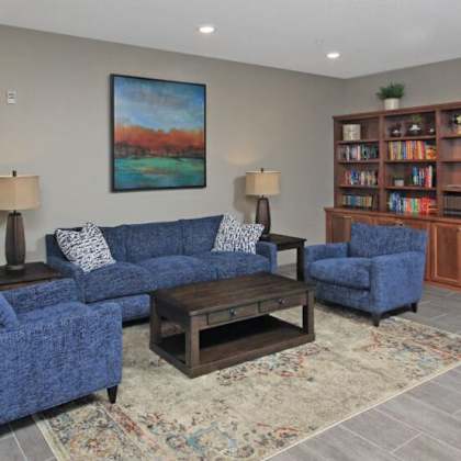 a living room with blue couches and a coffee table