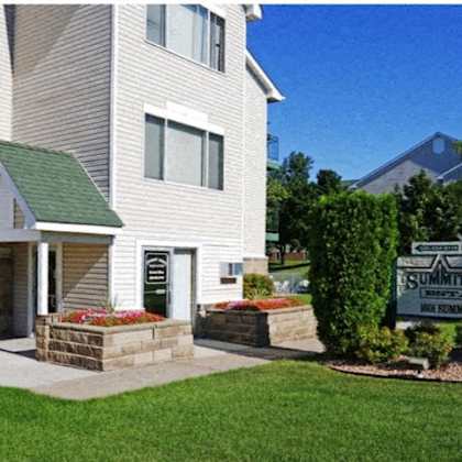 a house with a sign that says summit court in front of it.