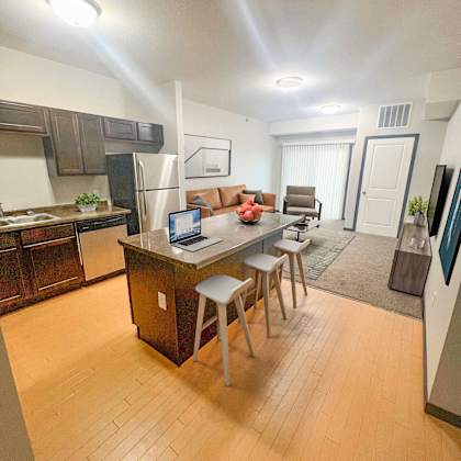 a kitchen with a table and chairs in the middle of the room.