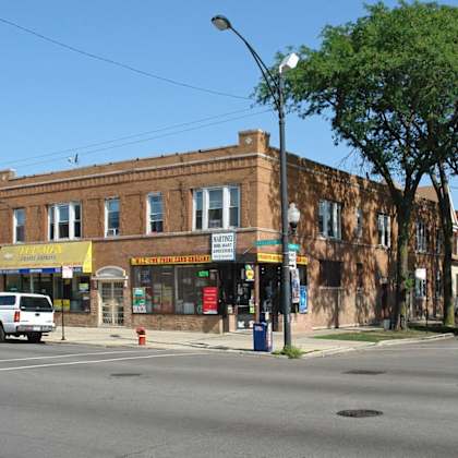 a brick building on the corner of a city street