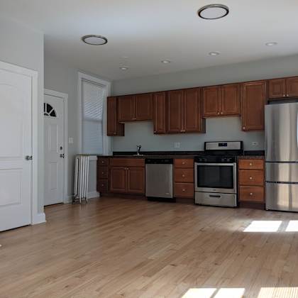 a kitchen with wooden cabinets and stainless steel appliances.