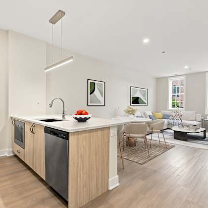 a modern kitchen with a wooden island and stainless steel appliances.
