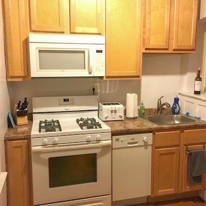 a kitchen with wooden cabinets and white appliances.