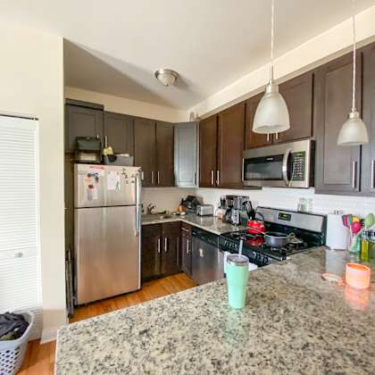 a kitchen with a granite counter top and stainless steel appliances.