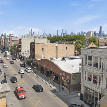 a city street with cars and buildings.