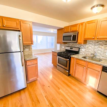 a kitchen with stainless steel appliances and wooden cabinets