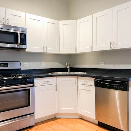 a kitchen with stainless steel appliances and white cabinets