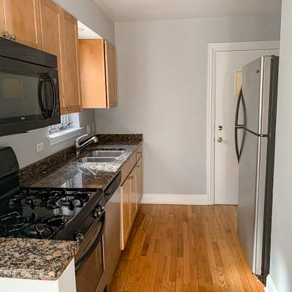 a kitchen with granite counter tops and a stove and a refrigerator