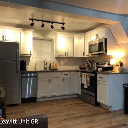 a kitchen with a refrigerator, microwave, and oven.