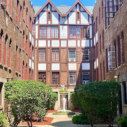 a courtyard in front of a building with a fountain