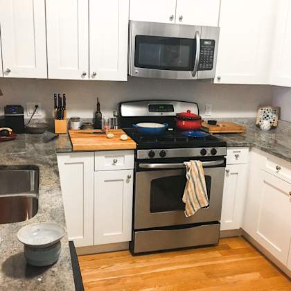 a kitchen with a stove top oven and a microwave above it.