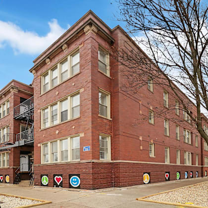 a red brick building with a fire escape on the left side.