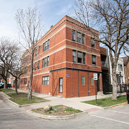 a red brick building with a blue sign on the front.