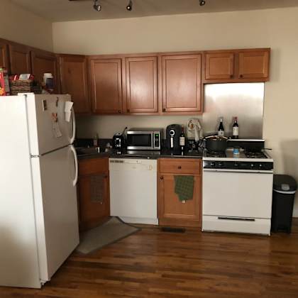 a kitchen with wooden cabinets and a white refrigerator.
