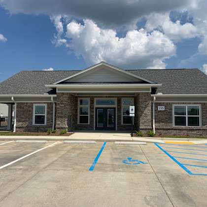 a building with a parking lot in front of it.