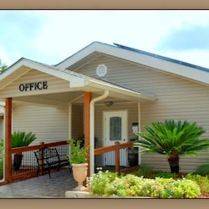 a small building with a porch and a sign that says "office".