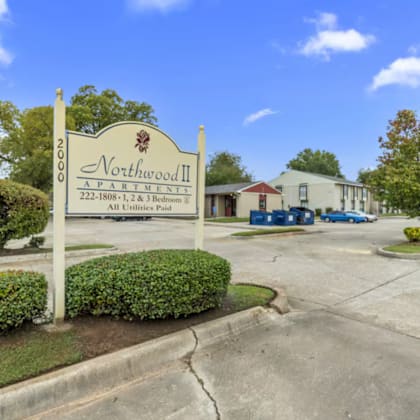 a sign for northwood ii, a 222-bedroom property, stands in front of a building.