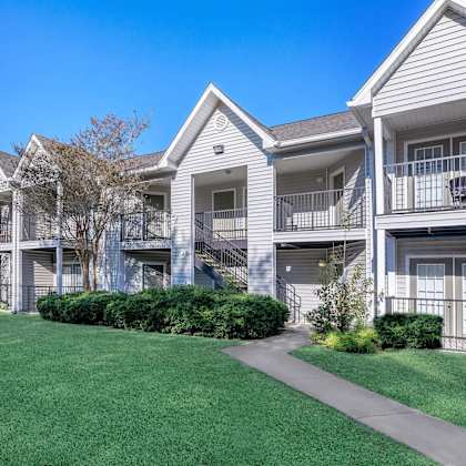 a row of townhouses with a clear blue sky above.
