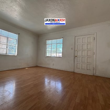 a room with wooden floors and a white door.