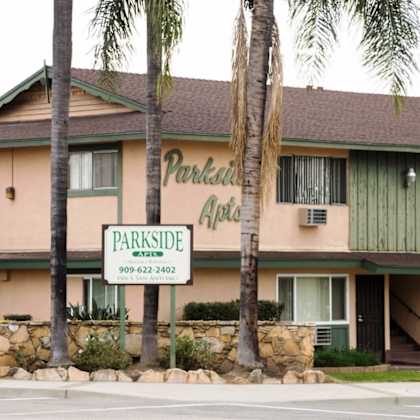 a building with a sign that says parkside apartments.
