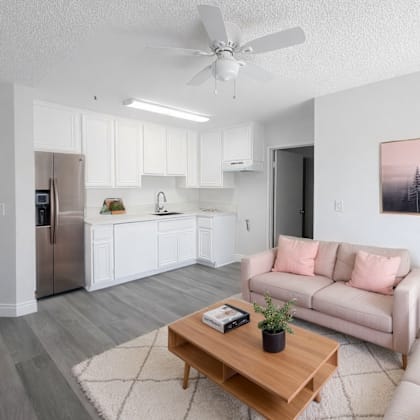 a living room with a couch, a coffee table, and a painting on the wall.