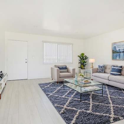 a living room with a couch, chair, and coffee table.
