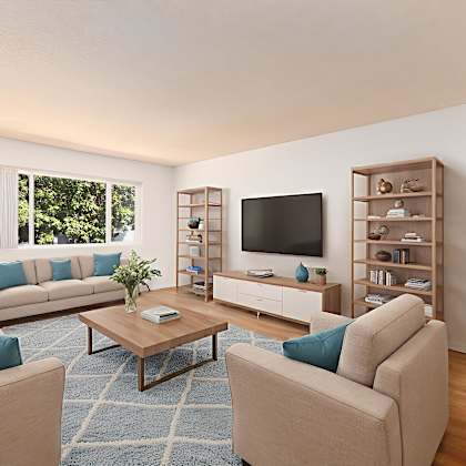 a living room with a large couch, a coffee table, and a television.