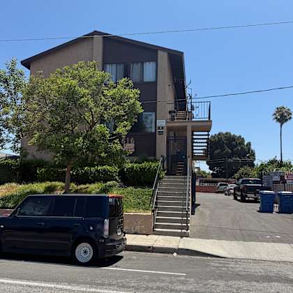 a blue car is parked on the side of a street.