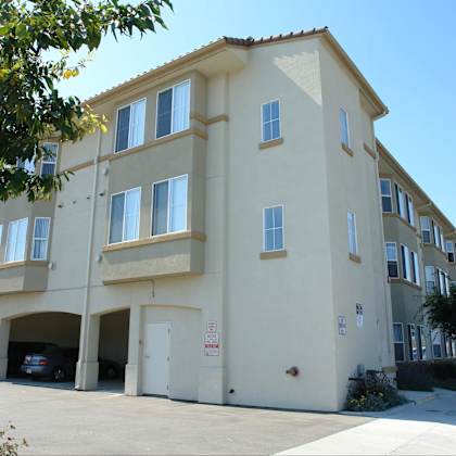 a building with a parking garage in front.